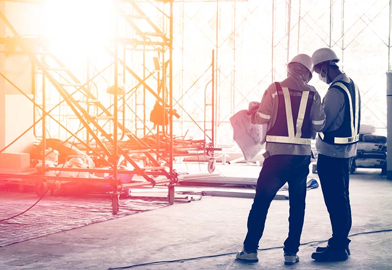 image for construction management; two foremen reviewing construction plans