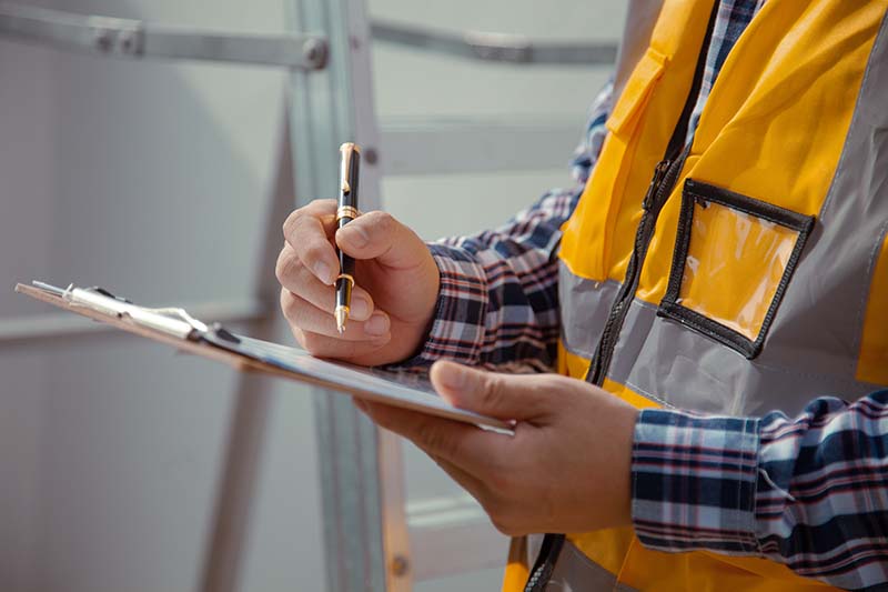 image for site surveys and estimating; man in construction vest with clipboard
